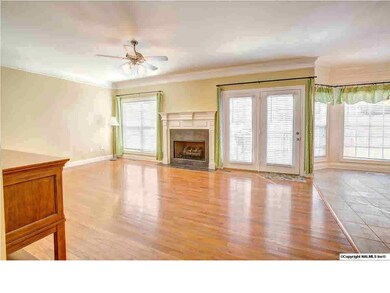 Spacious Family Room is anchored by a fireplace and overlooks the large backyard.