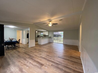 Living area with wood finished floors, ceiling fan