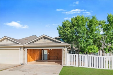 View of front of house with a garage, roof with s
