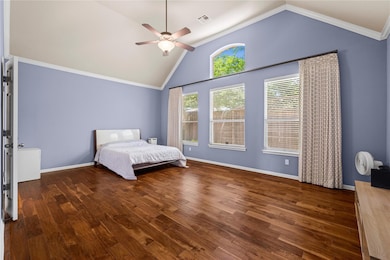 Bedroom with lofted ceiling, visible vents, a cei