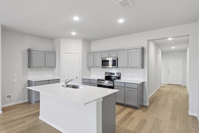 Kitchen in the Holden home plan by Trophy Signature Homes – REPRESENTATIVE PHOTO