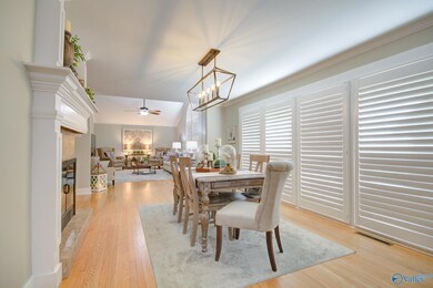 19X11  DINING ROOM OPEN TO GREAT ROOM.  DOUBLE SIDED FIREPLACE SERVES DINING ROOM AND KITCHEN.  HARDWOOD FLOORING AND PLANTATION SHUTTERS.