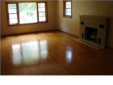 Large rooms aith hardwood floors.