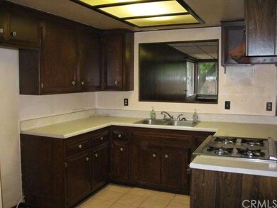 Kitchen has pass-through to wet bar in family room