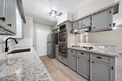 All new Stainless Steal appliances pop with the light counters and backsplashes.