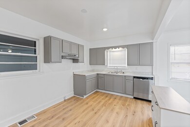 Kitchen featuring sink, gray cabinets, stainless s