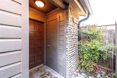 Doorway to property featuring stone siding