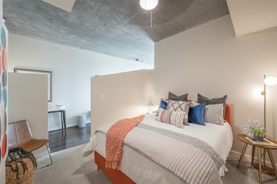 Primary bedroom loft featuring sweeping high ceilings and a mirrored closet!