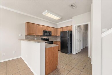 Kitchen featuring backsplash, black appliances, or