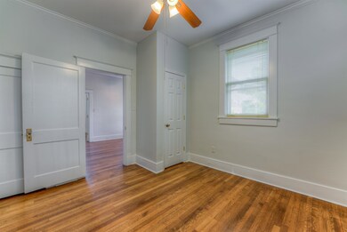Unfurnished bedroom with hardwood / wood-style flo