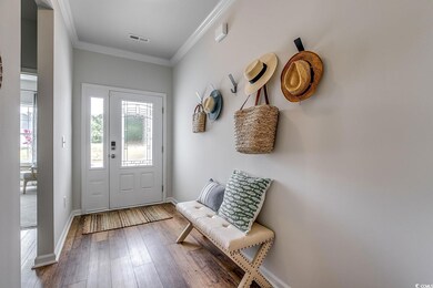 Mudroom with wood-type flooring and ornamental mol
