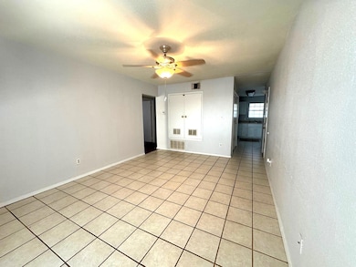 Unfurnished room with light tile patterned flooring, a ceiling fan, and a textured ceiling