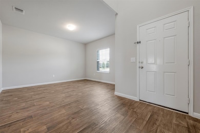 Entrance foyer with wood finished floors, baseboa