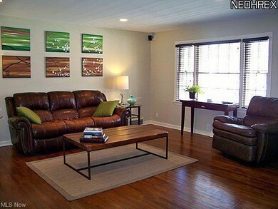 Spacious living room with gleaming wood flooring