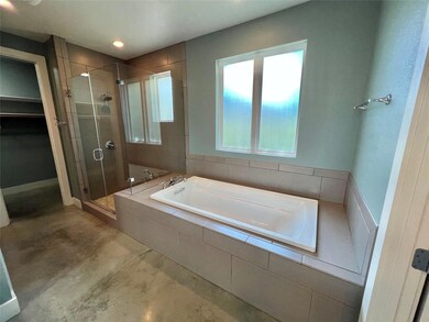 Bathroom featuring a shower stall, a garden tub, 