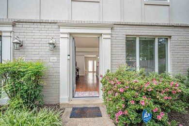 Entrance to property with brick siding and stucco siding