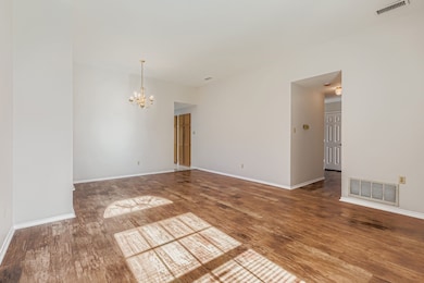 Unfurnished room with a chandelier and wood finished floors
