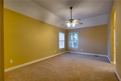 THE OVERSIZED MASTER SUITE BOASTS LUSH CARPETING AND TREE-LINED VIEWS OF THE YARD.