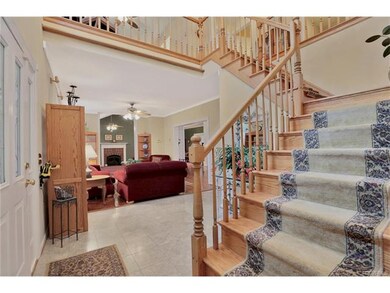 Front Foyer Grand Stairway with Hardwood Finishes