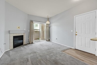 Unfurnished living room featuring a tiled fireplac