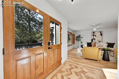 Entrance foyer with wood finished floors and baseb
