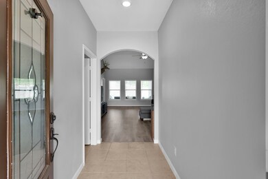 Bright entryway with tiled flooring leading into a