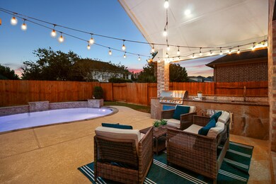 Covered Patio with Outdoor Kitchen with built-in grill and sink.