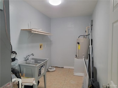 Laundry room featuring washer hookup and light tile patterned flooring