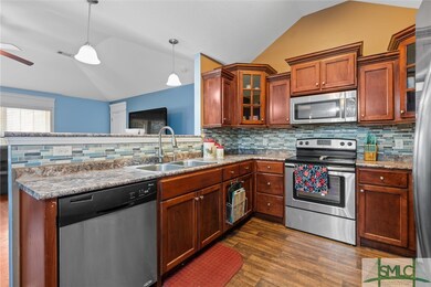 Kitchen with abundant real wood cabinetry.