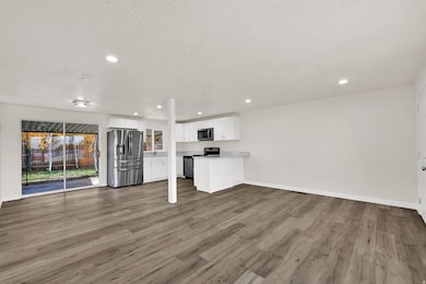 Unfurnished living room featuring light wood-style floors, recessed lighting, and a textured ceiling