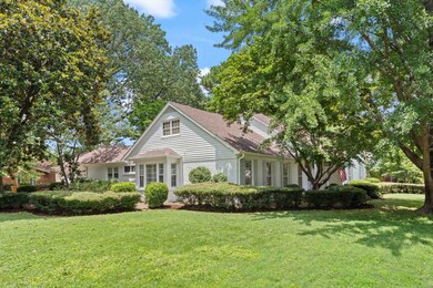 View of front of house featuring a front yard and a shingled roof