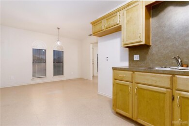 Kitchen with pendant lighting, tasteful backsplash, and sink