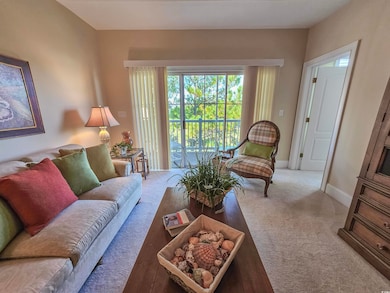 Carpeted living room featuring baseboards