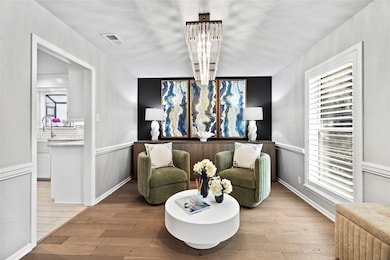 Sitting room with healthy amount of natural light and a wainscoted wall
