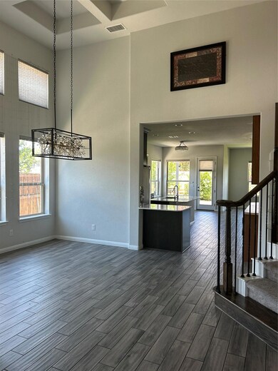 Unfurnished living room featuring a towering ceil