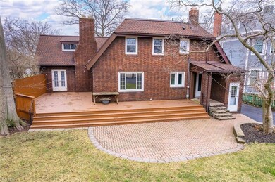 Spacious deck with full width stairs and brick paver patio.