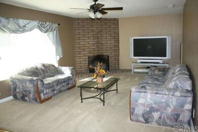 Living room with brick fireplace.