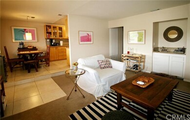 Alternate view of living room with wet bar and ste