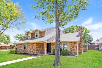 Traditional-style house with a front yard, brick s