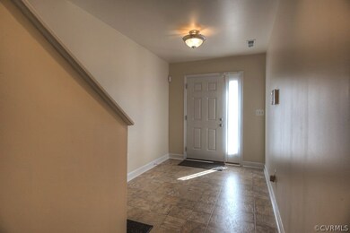 Foyer with access to garage, bedroom 2 and stairs taking you to 2nd level
