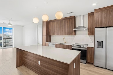 Kitchen with modern cabinets, a sink, visible ven