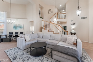 Living area with high vaulted ceiling, stairs, a c
