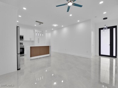 Unfurnished living room with ceiling fan, recessed