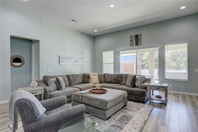 Living room featuring wood finished floors and recessed lighting