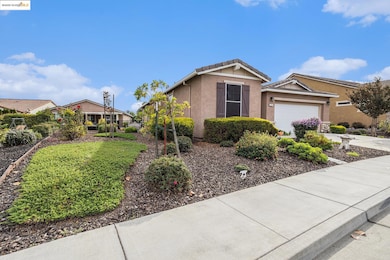 Single story home featuring stucco siding, driveway, a garage, and a tiled roof