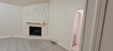 Stone fireplace in family room plus ceramic tile flooring.