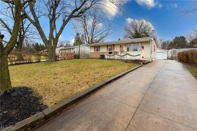 Single story home featuring a garage and a front yard