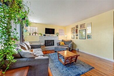 Step inside to the expansive living room with stunning hardwood floors and gas fireplace.