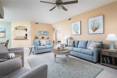 Tiled living area with visible vents, arched walkw
