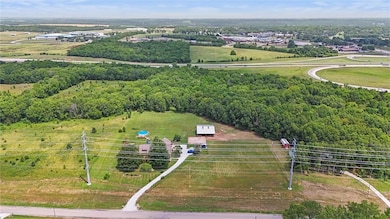 View of property looking north.  K10 is behind this property and beyond that is Desoto High Schools and Admin building.  Casey's gas station and some strip retail.  The upper left corner shows Merch.